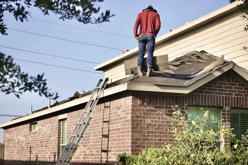 Professional roofer working on a residential roof in Cougar